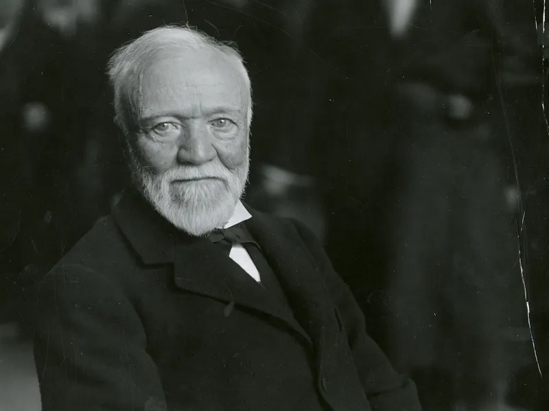 Black and white portrait of Andrew Carnegie wearing a black suit.
