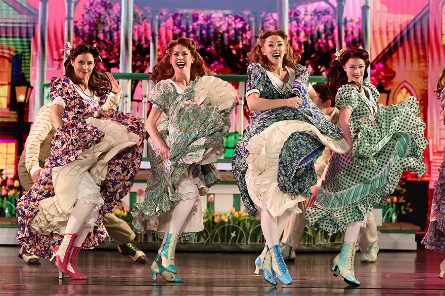 Scene from the Schmigadoon musical, with ladies swishing their skirts.